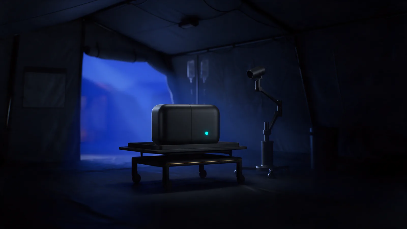 A sealed portable unit on an equipment trolley beside a mobile imaging arm inside a field tent at dusk, a single status light lit on its face.